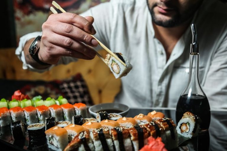 man are going to eat sushi ginger wasabi soya sauce side view